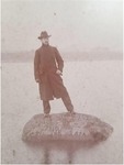 Photograph of Walter Molster standing upon Indian Head Rock by Unknown.